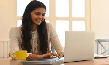 Online Accounting Associate Degree Student Taking Classes on Laptop